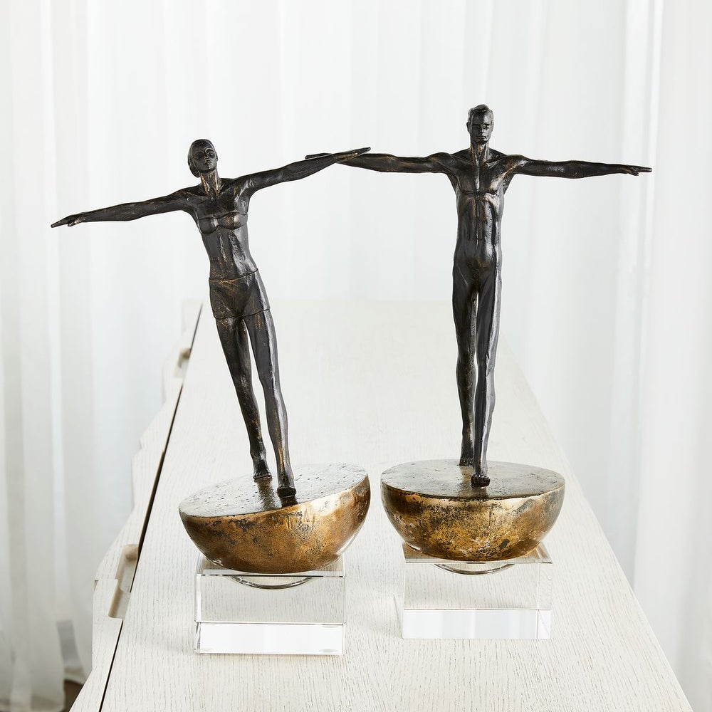 Man and Woman Finding Balance Sculptures side by side. 