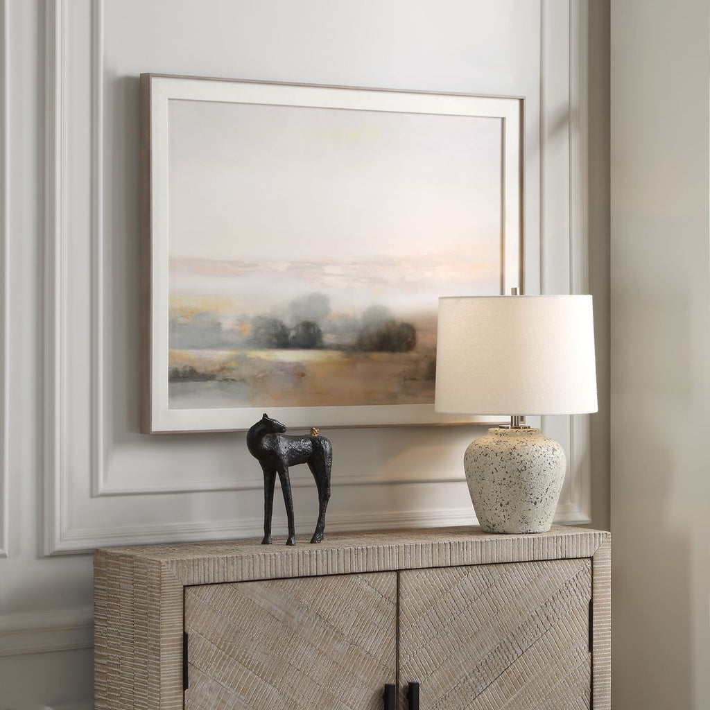 Horse and Friend Sculpture pictured here in a foyer on a console table next to a lamp.