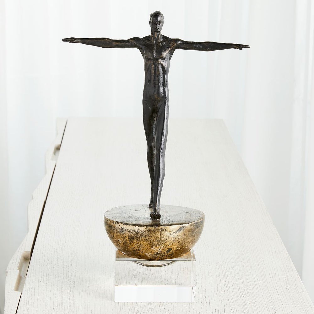 Detailed front view of the Man Finding Balance Sculpture, highlighting its sleek design and textured finish.