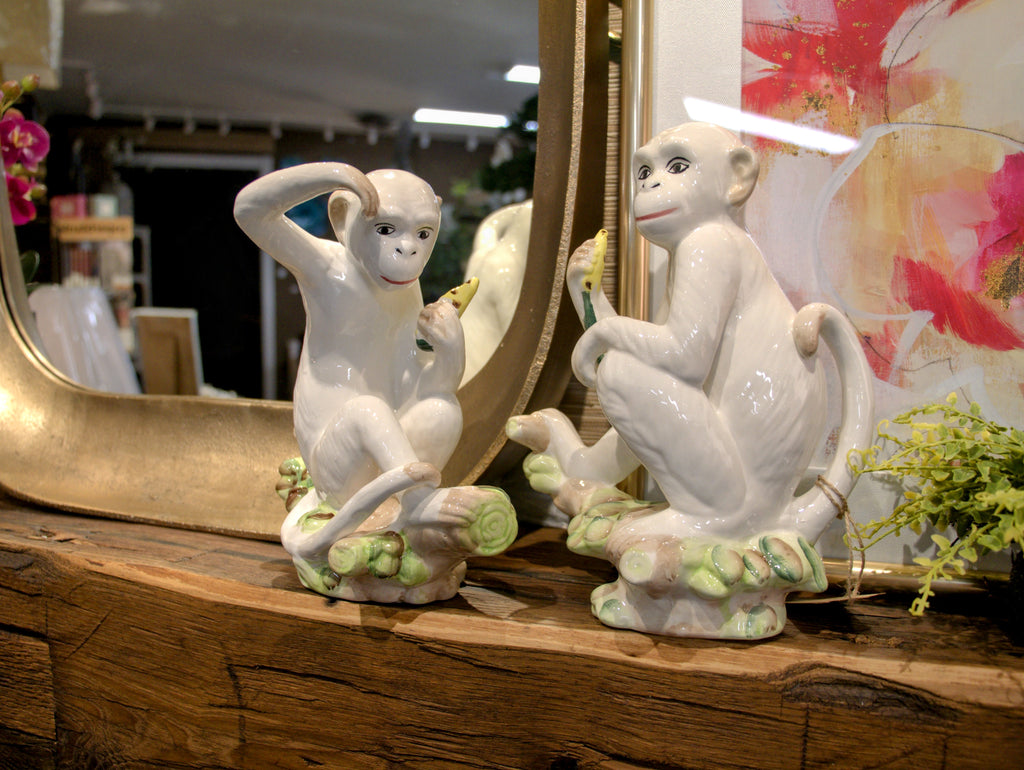 Set of 2 playful monkey sculptures styled on a shelf for a unique home décor accent.