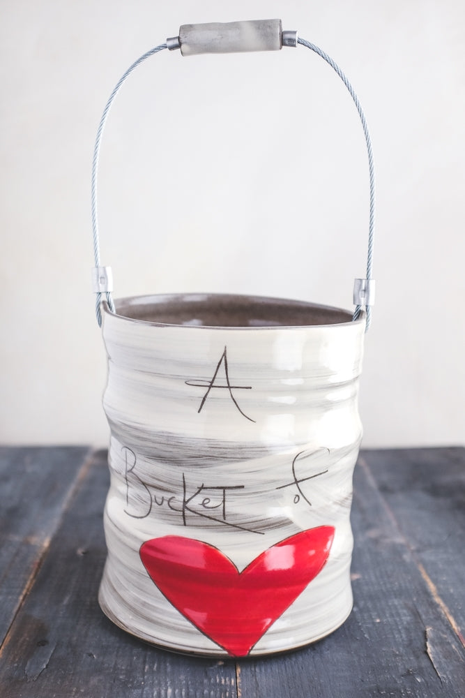 A Bucket of Love handmade ceramic vase by ZPots, wheel-thrown and inscribed with a heartfelt message. Perfect for flowers or as a decorative accent.